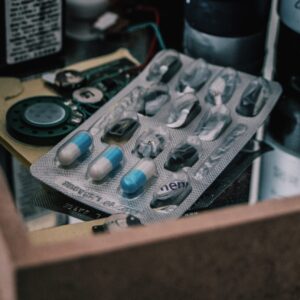 safety packaged blue and white pills in a box of a variety of items